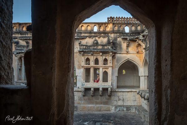 Ruins of an ancient structure offering a glimpse of ornate architecture and a quiet, contemplative atmosphere.