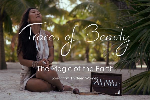 A woman sits peacefully on the beach amidst palm trees, embodying tranquility and connection to nature.
