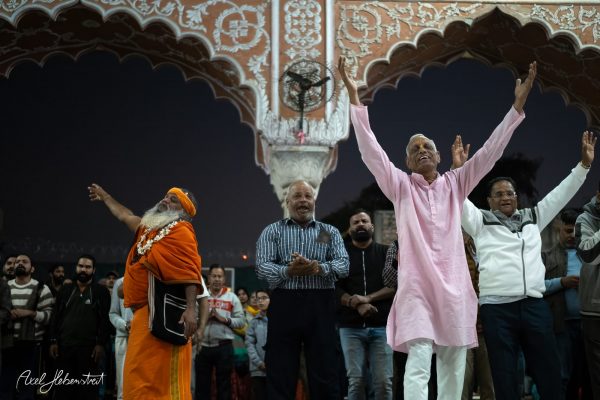 Festive gathering in a vibrant setting, with joyful participants celebrating amid ornate architecture at dusk.